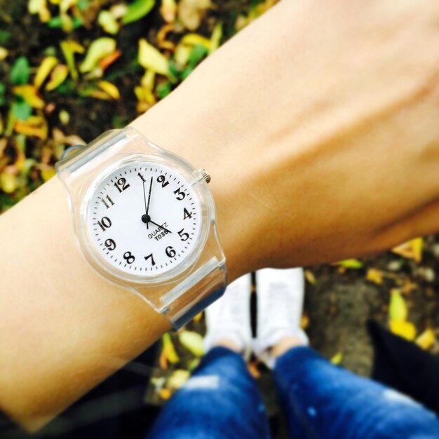 Photo close-up of hand wearing wristwatch