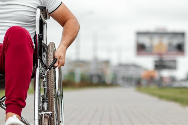 Photo close-up of a hand on a wheelchair wheel. the concept of a wheelchair, disabled person, full life, paralyzed, disabled person, happy life.