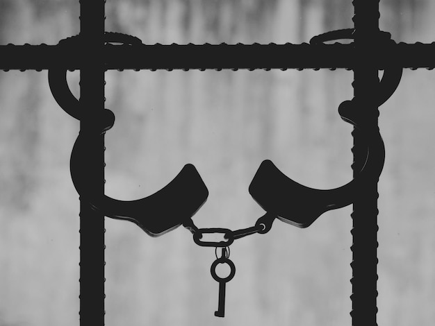 Photo close-up of handcuffs on security bars