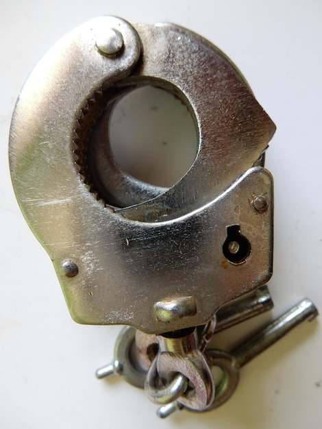 Close-up of handcuffs on white background