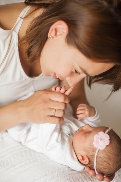 Close-up. The handle of the baby in mother's hands. Cute newborn baby sleeping in mother's arms. Motherhood.