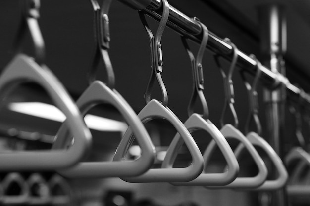 Photo close-up of handles hanging in bus