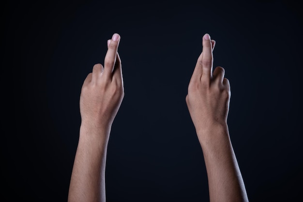 Close-up of hands against black background