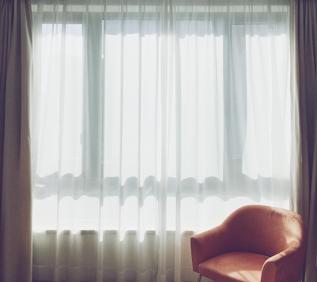 Close-up of hands against window