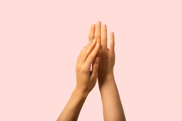 Photo close up hands applying cream perfect skin and neat neutral nails