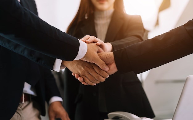 Close up on hands of business people join together their hands together on unity concept in morning light