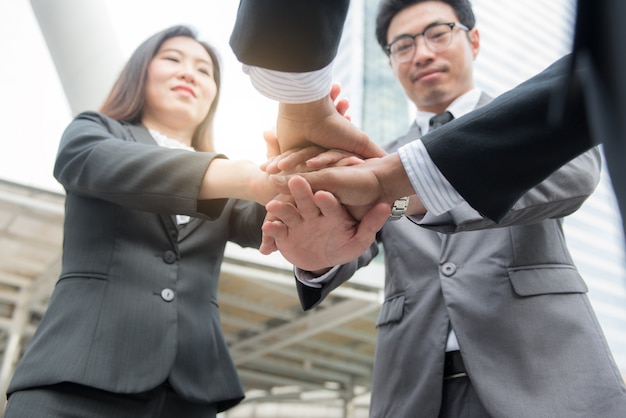 Close-Up of hands business team showing unity with putting their hands together.