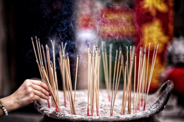Close-up of hands candles in temple