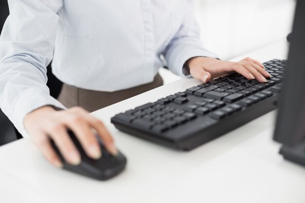 Close up of hands computer keyboard and mouse