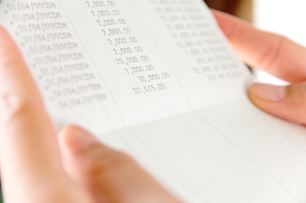 close-up of hands holding bank book