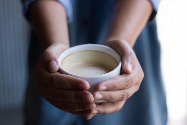 Close-up of hands holding coffee cup