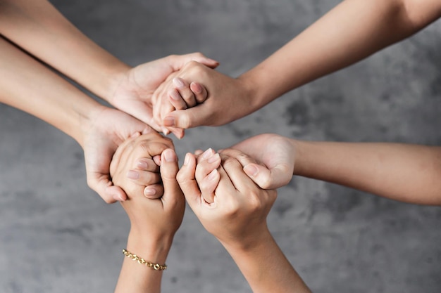 Close up of hands holding each other for togethersess concept