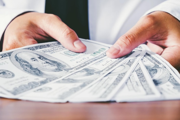 Close-up of hands holding fanned out paper currency