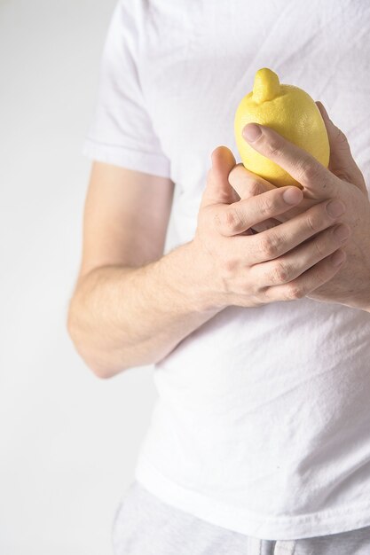 Close up of hands holding a lemon