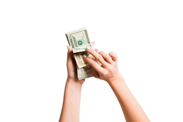 Close-up of hands holding paper currency against white background