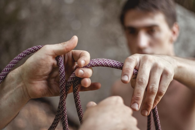 Close-up of hands holding rope