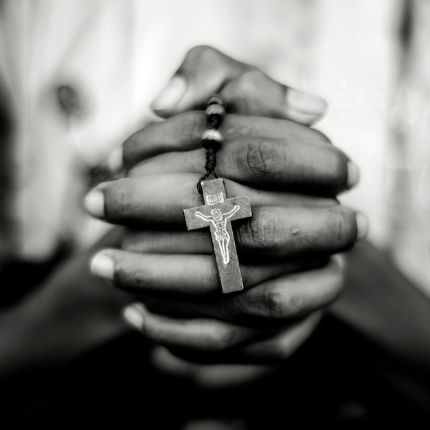 Close-up of hands holding rosary