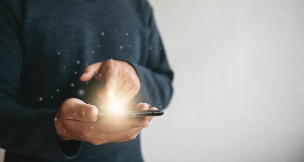 Close up hands holding smartphone. man using cellphone for marketing  and searching data and social media on internet.technology business investment concept