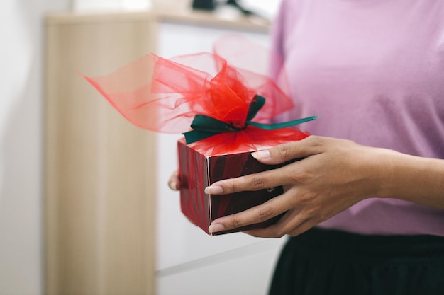 Close up hands holding surprise gift box Boxing day Christmas and Mother's day concept