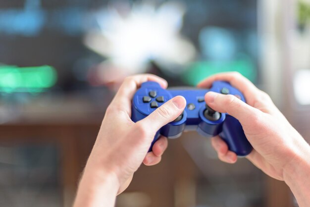 Photo close-up of hands holding video game remote control