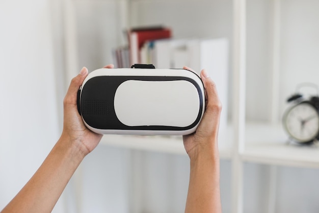 Close-up of hands holding virtual reality glasses at the office