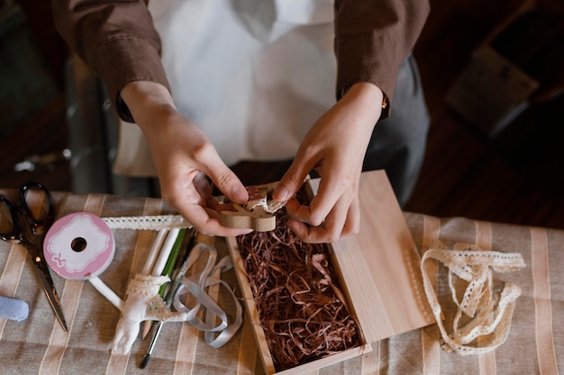 Close up hands holding wooden piece