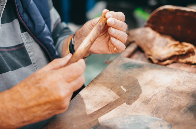 Photo close up of hands making cigars process of making traditional cigars from tobacco leaves