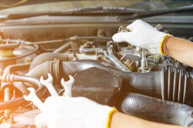 Close up hands mechanic doing car service and maintenance