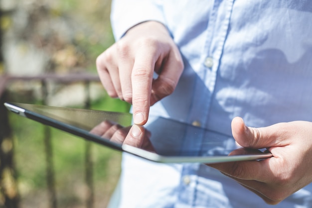 close up hands multitasking man using tablet 