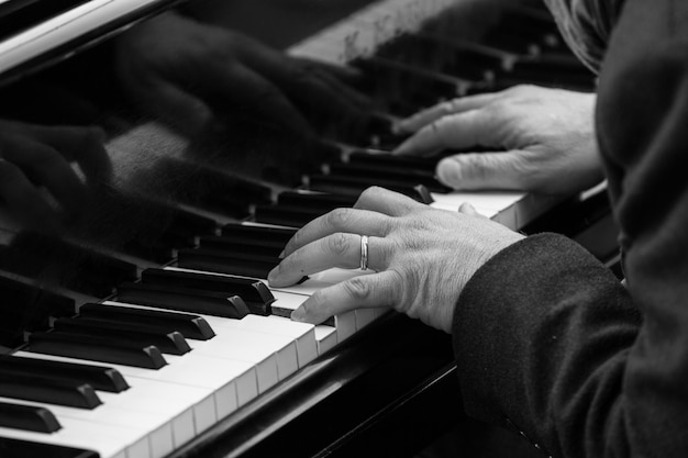 close-up of hands playing piano