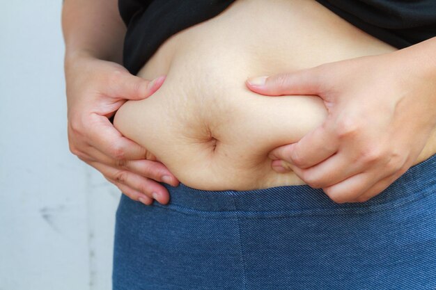 Close-up of hands touching belly