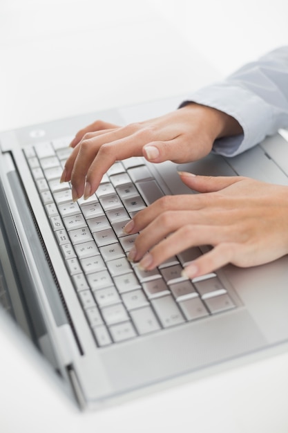 Close up of hands typing on laptop keyboard