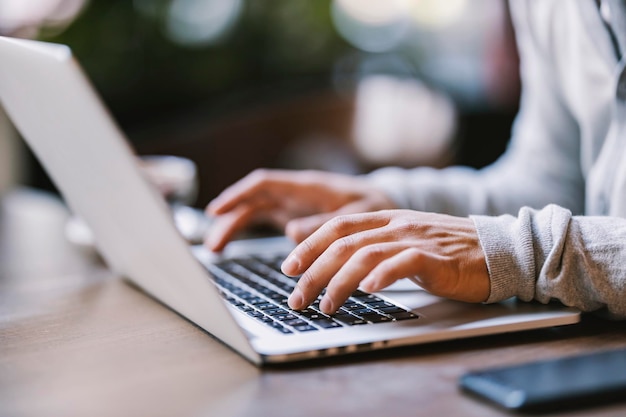 Close up of hands typing on a laptop