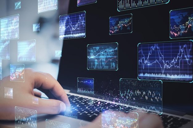 Close up of hands using notebook with various forex screens on blurry background Cryptocurrency bticoin trading and finance concept Double exposure