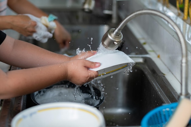 Close up hands washing dishes