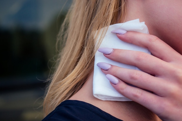 Close-up hands with long nails manicure of woman using a antibacterial wet napkin wipe