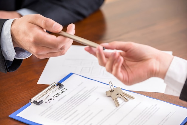 Close-up of hands with a pen to signing a contract.