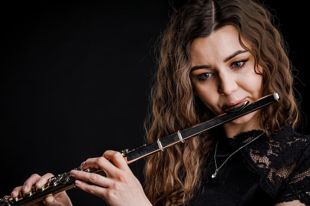 Close-up of the hands of a woman playing the flute. Musical concept.