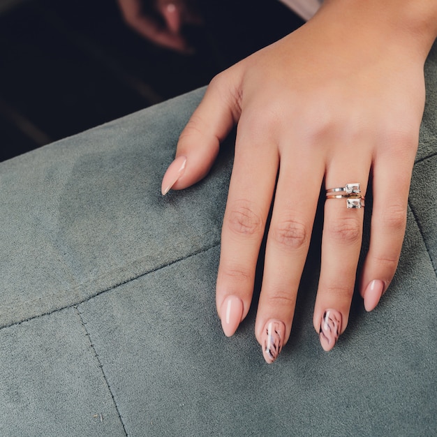 Close up of hands of woman showing the ring with diamond. She is engaged.