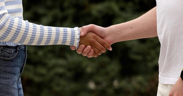 Close-up of handshake African woman and white man.