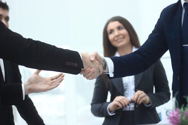 Close up.handshake of business partners in the background of the office.