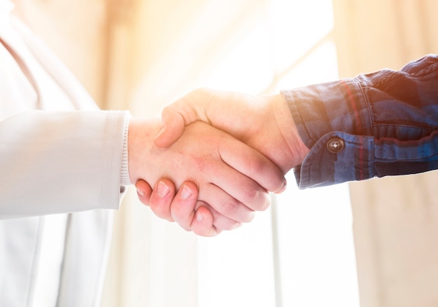 Photo close-up of handshake of business partners in office