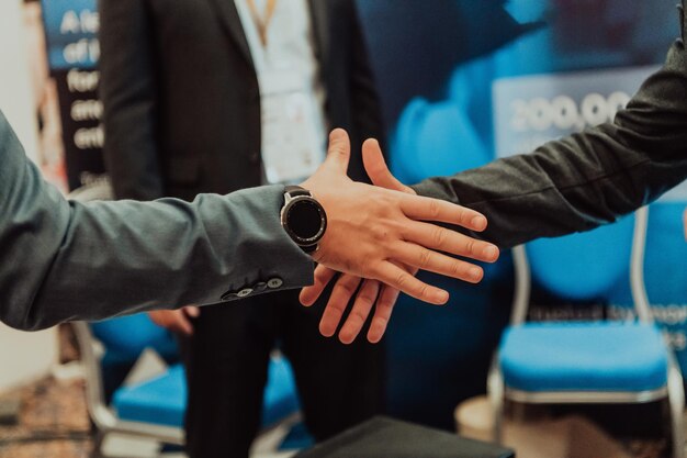 Close up a handshake, businessman together creates a mutually beneficial business relationship. The economic graph on the table.