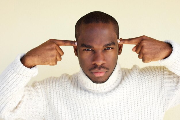 Close up handsome african american man with fingers pointing to head