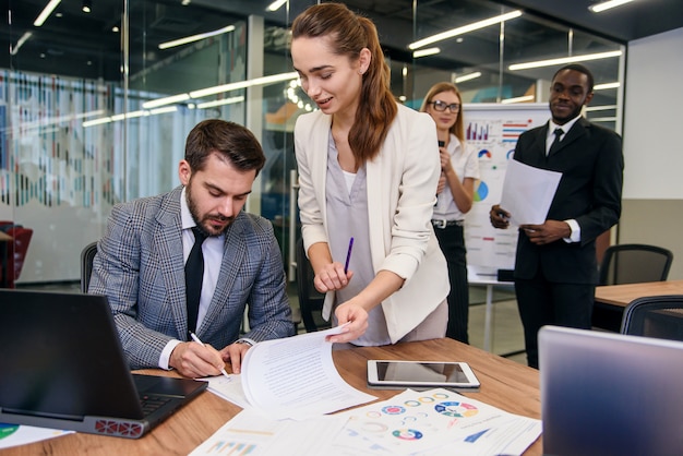 Close up handsome businessman signing partnership agreement concept