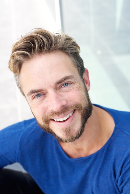 Close up handsome man with beard smiling