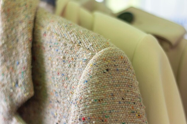 Close-up of hangers with different clothes.Women's jackets hang on a hanger.Selective focus,shallow depth of field.