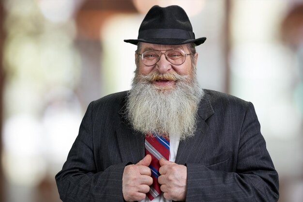 Photo close up of happy bearded man looking at camera with a smile.