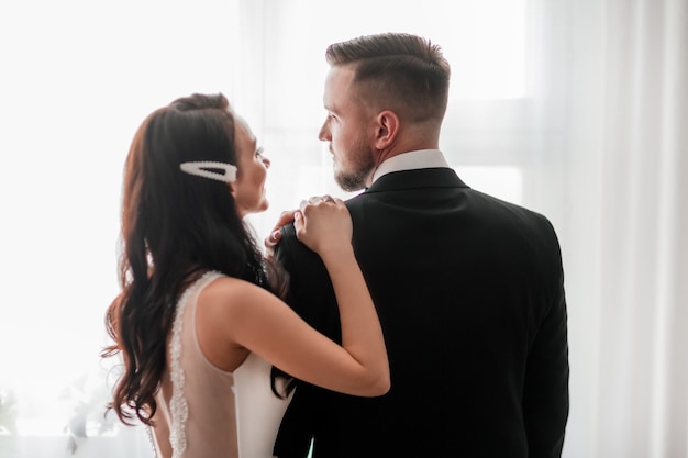 Close up. happy bride and groom looking at each other