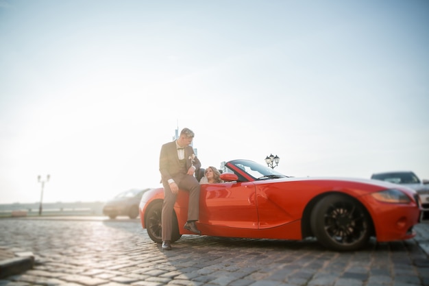 Close up. happy bride and groom sitting in a luxury car.